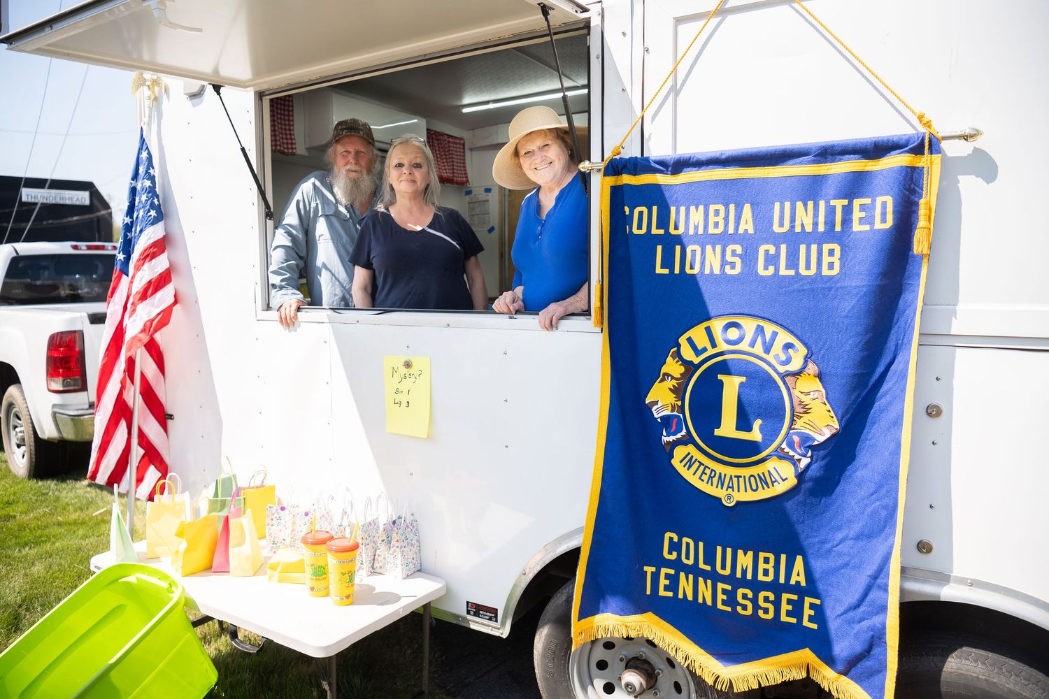 Columbia United Lions Club members serve lemonade from a trailer booth at an outdoor event in Columbia, Tennessee.
