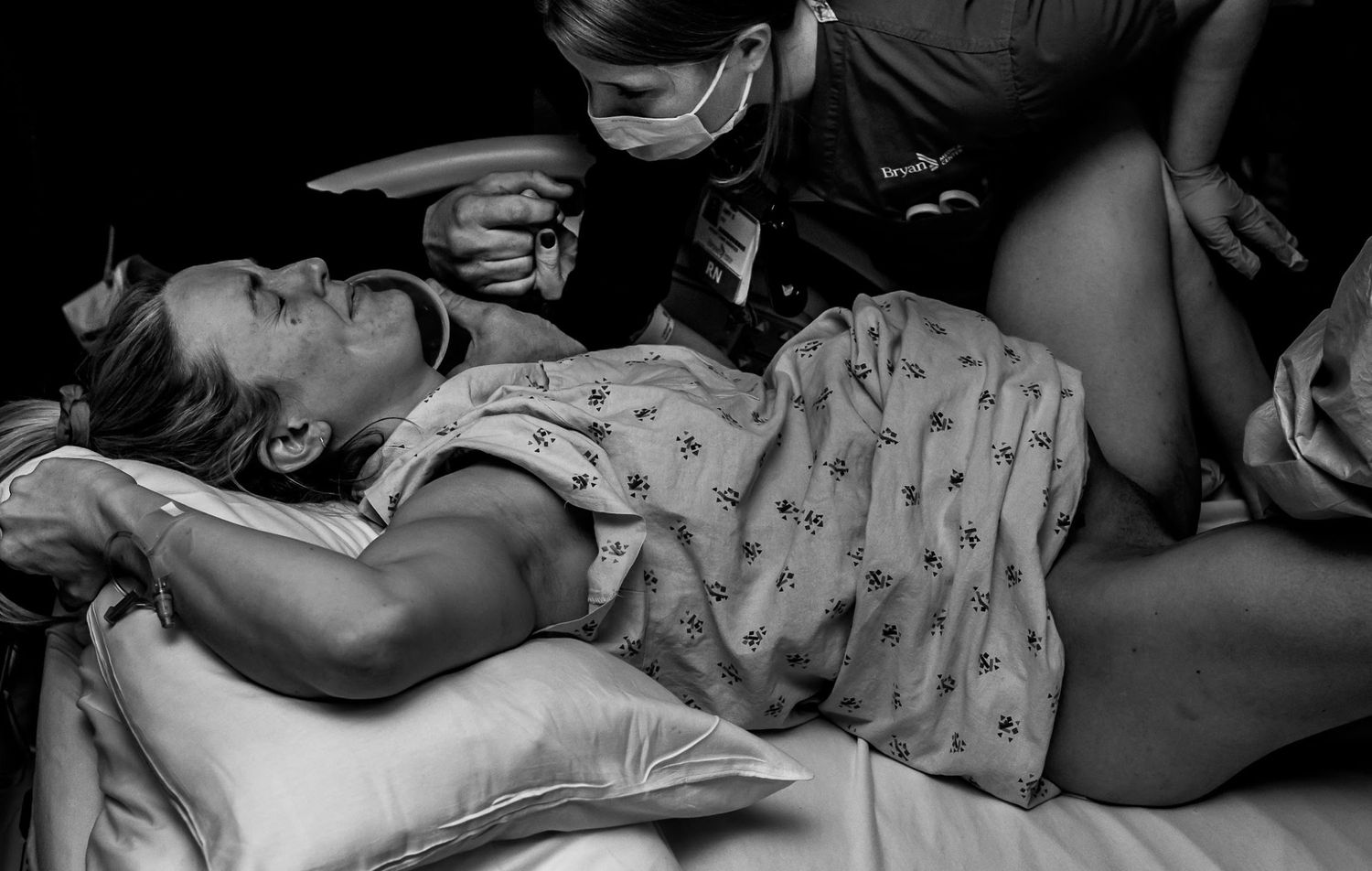 Black and white image of the moments before a laboring mother's baby emerges