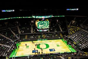 Aerial view of the Oregon Ducks basketball court with green O logo at Matthew Knight Arena.