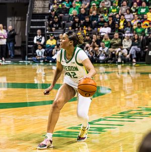 Oregon Ducks women's basketball player #42 dribbles the ball during a home game at Matthew Knight Arena.