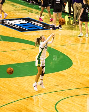 Oregon Ducks female basketball player shoots ball during NCAA tournament game on home court.