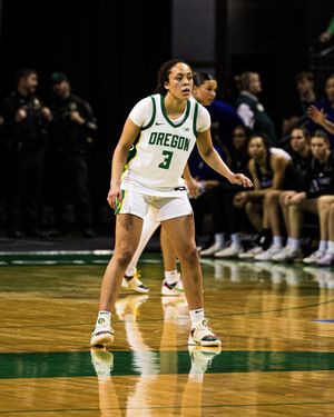 Oregon Ducks women's basketball player #3 in defensive stance on court during a game.