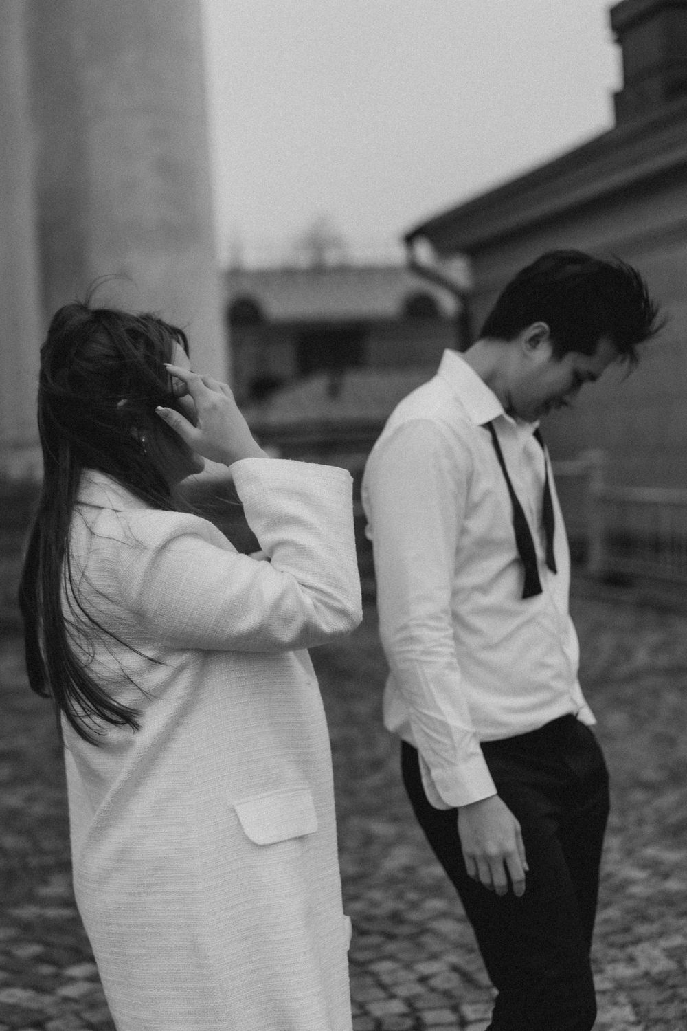 Black and white engagement photo of a couple laughing near Helsinki Cathedral in Helsinki