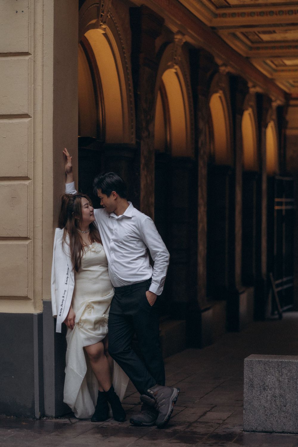 Engaged couple walking together near Helsinki Cathedral during a relaxed engagement session