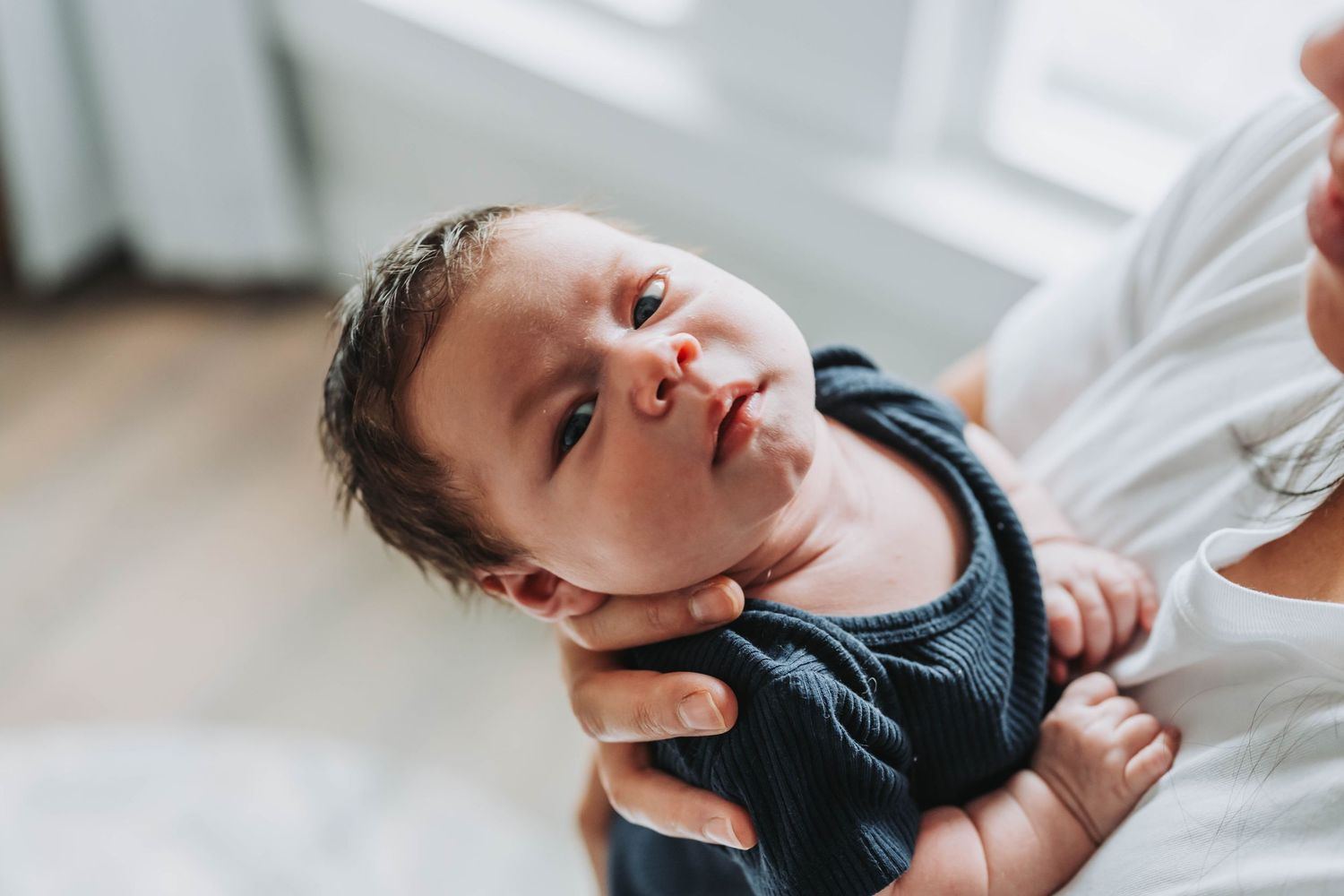New baby boy looks at camera in session with K. Manchuck Photography in Hudson, NY