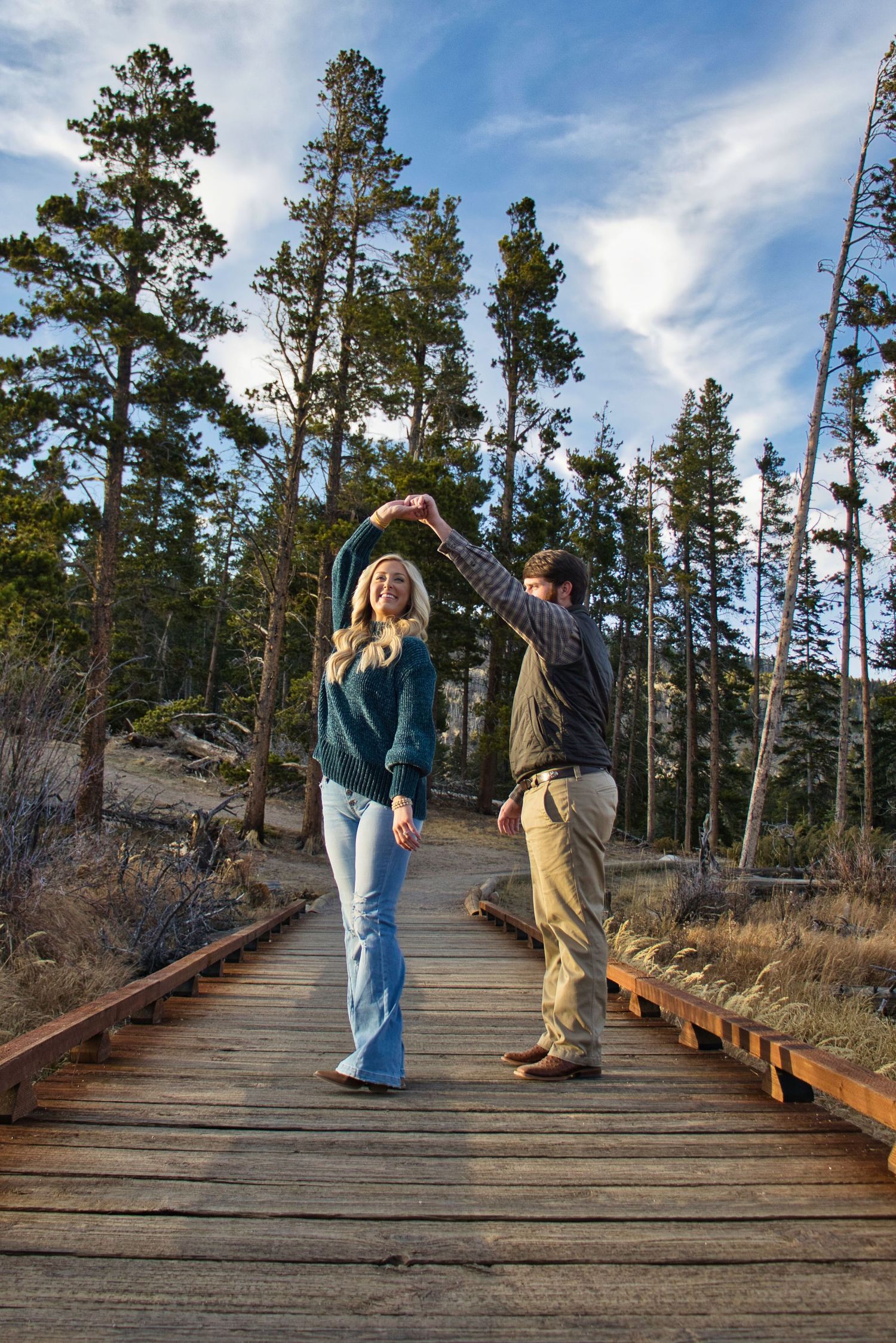 Dancing in celebration of just getting engaged at Sprague Lake. Pixcapades | The Rocky Mountain Proposal Photographer