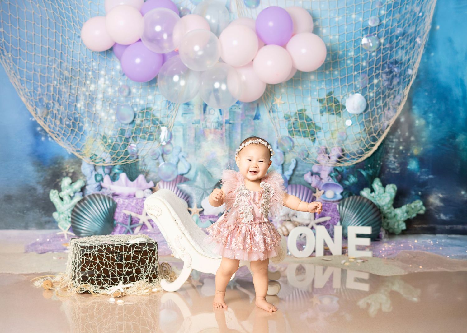 Newborn photography Covina CA sibling kissing baby girl in soft neutral studio setup