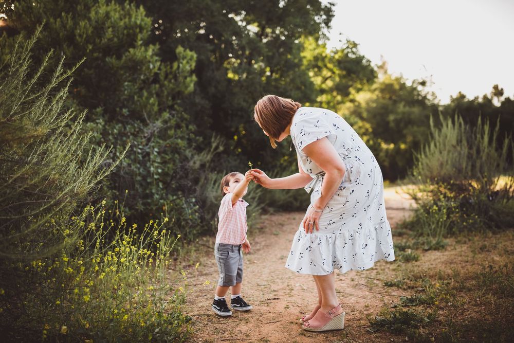 A series of candid outdoor moments captured at sunset showing figures exploring nature together on a dirt path.