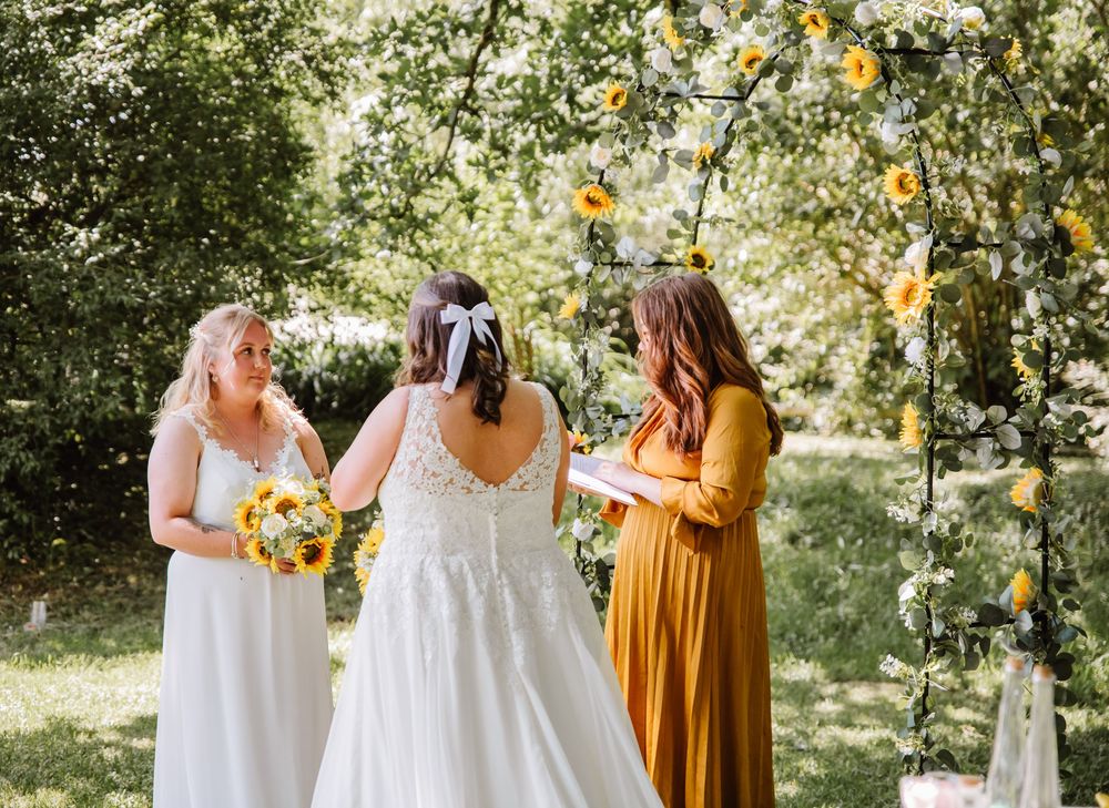 Gaggle of Geese Tipi outdoor wedding venue in Dorset. LGBTQ+ wedding photographer Dorset. Sunflower wedding bouquet and sunflower arch