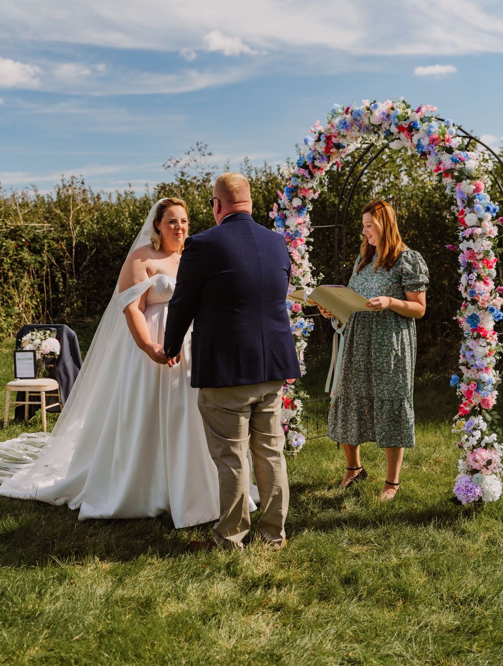Ceremonies by Laura Bell at Moor Farm in Chickerell Weymouth. Floral arch way by a Wedding Photographer Dorset