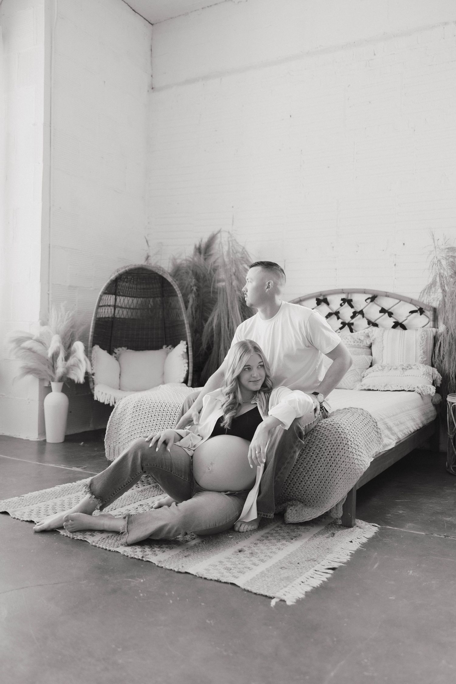 Black and white photo series showing a figure lying on the floor in different positions with draped fabric and props.