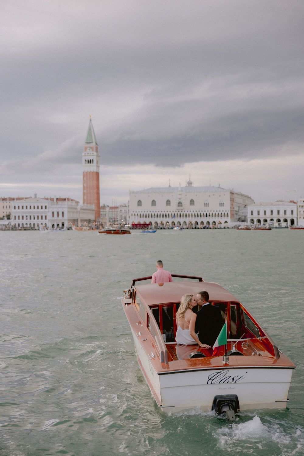 Wedding photo shoot on a boat departing from San Giorgio Maggiore at the sunset