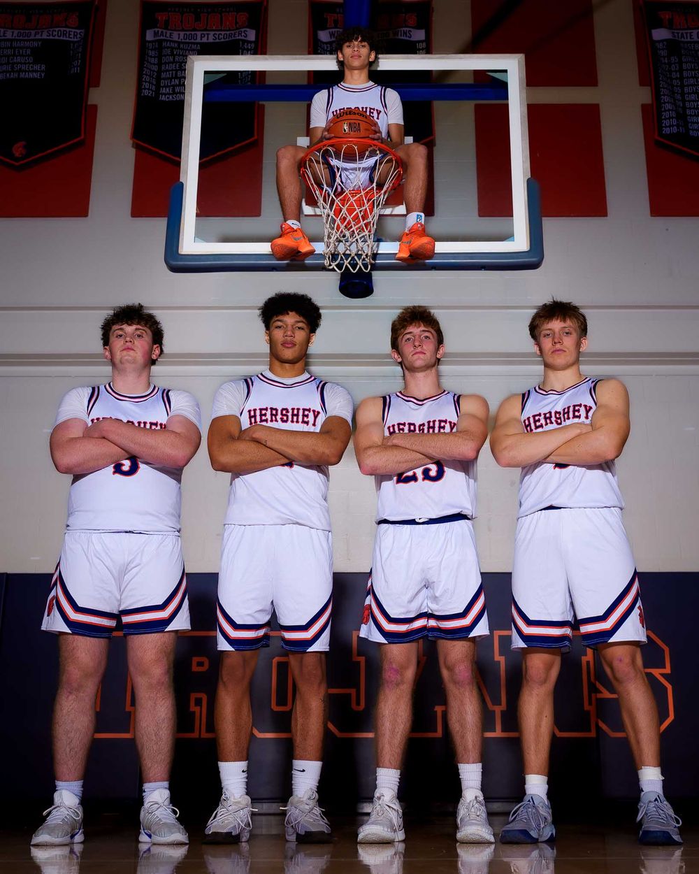 Hershey boys basketball seniors standing beneath the hoop for a classic team portrait during Media Day.