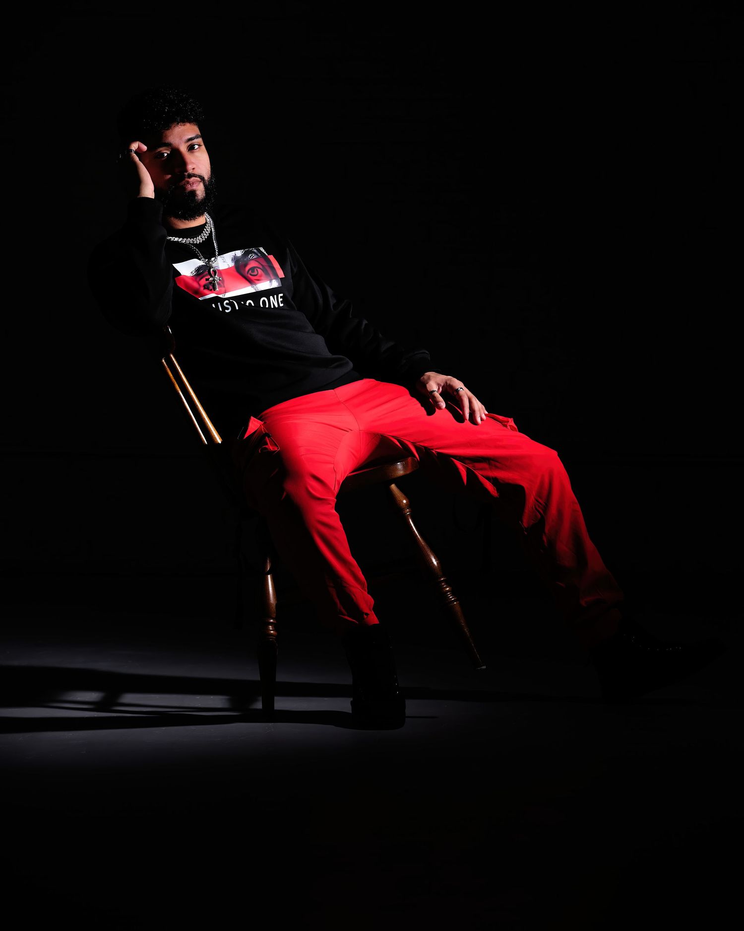 David G Holt Photography - Dynamic dance pose in red outfit with dramatic spotlighting against dark background.