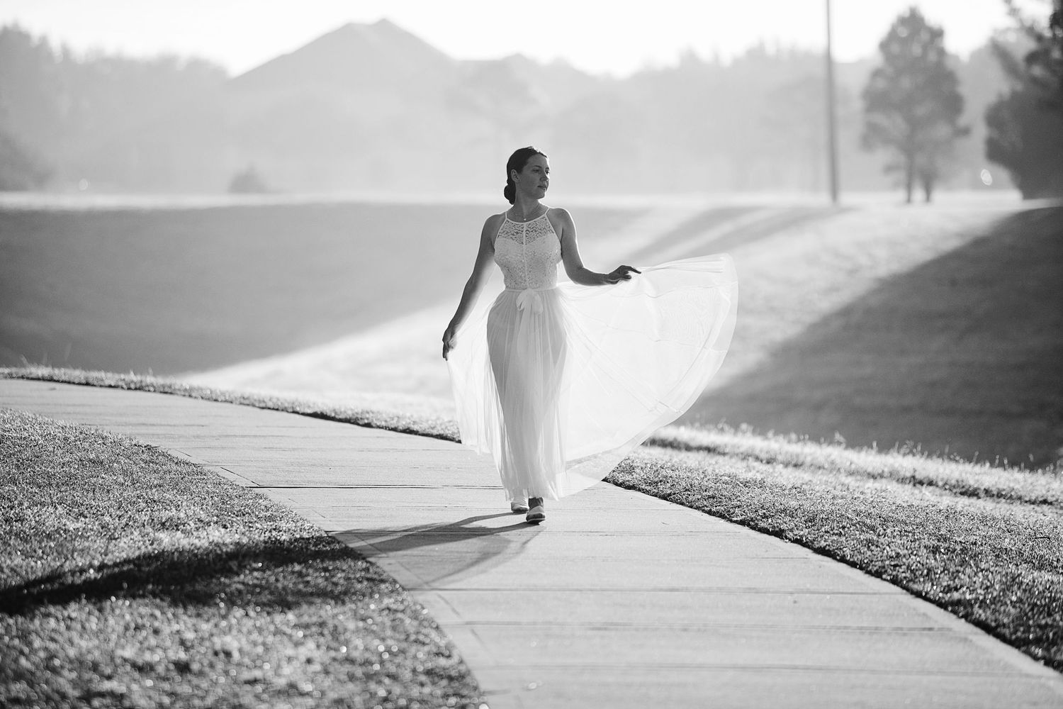 Engagement photos in Hermann Park Houston with trees, walking paths, and natural romantic atmosphere