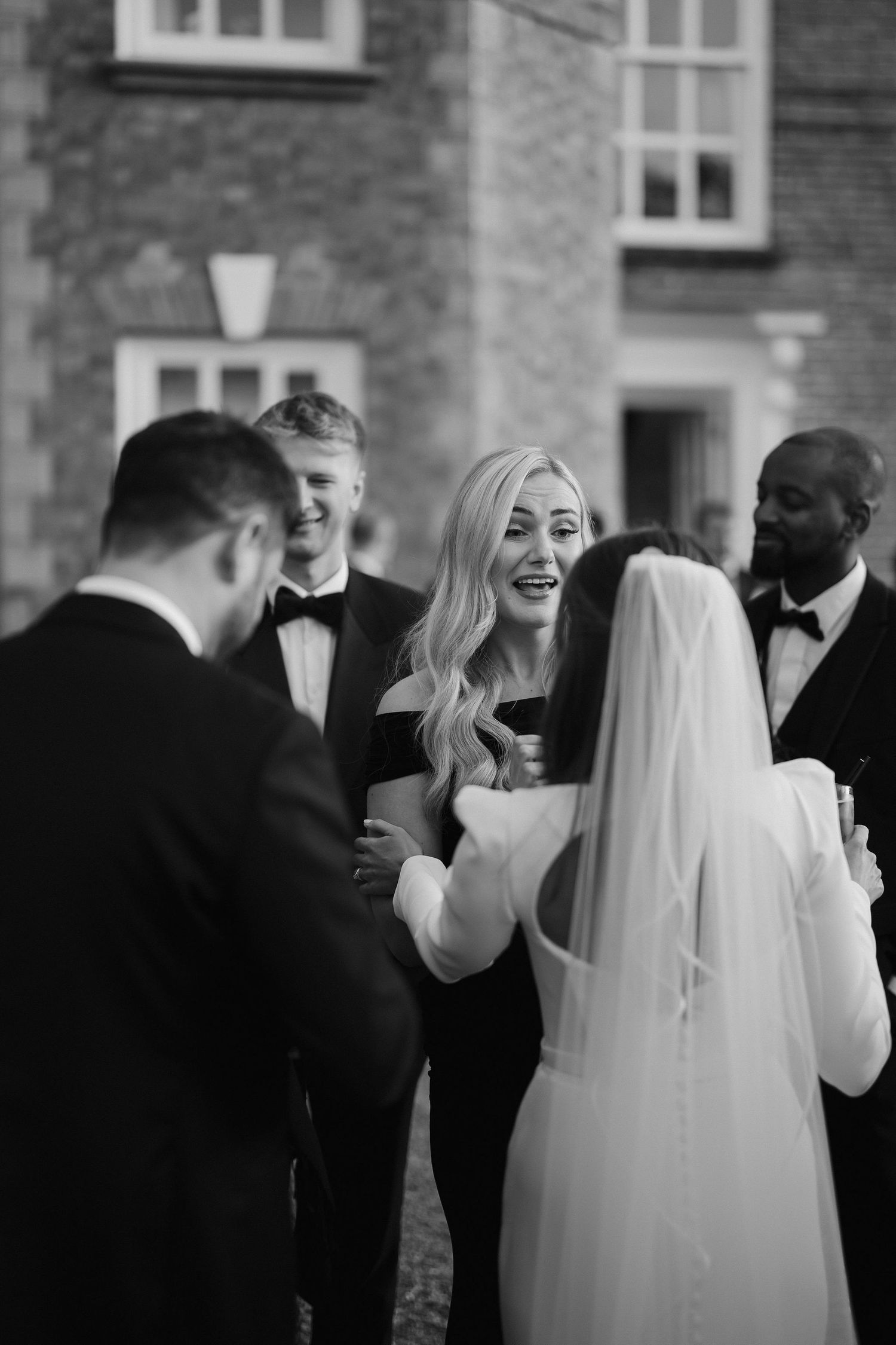 wedding guests greeting bride and groom in the gardens outside Iscoyd park