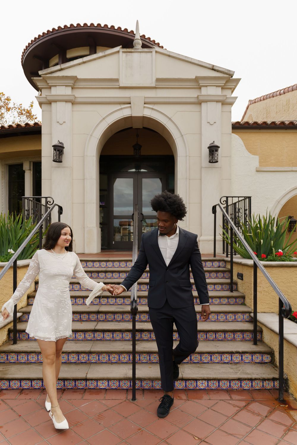 A sequence of candid moments between a couple on Spanish colonial architecture steps.