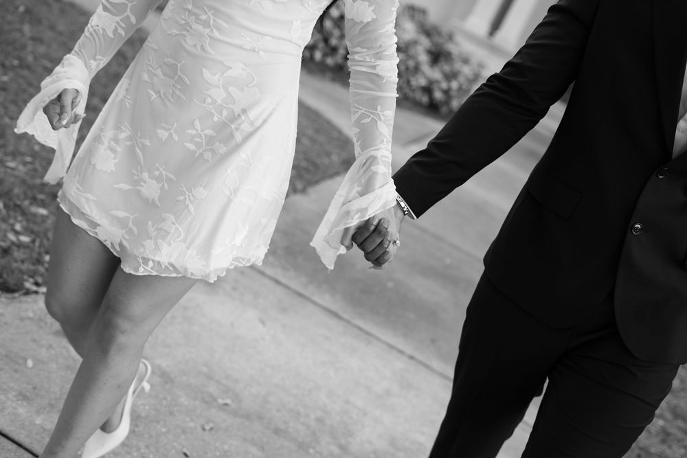 Close-up details of a couple's formal attire and intimate poses against architectural elements.