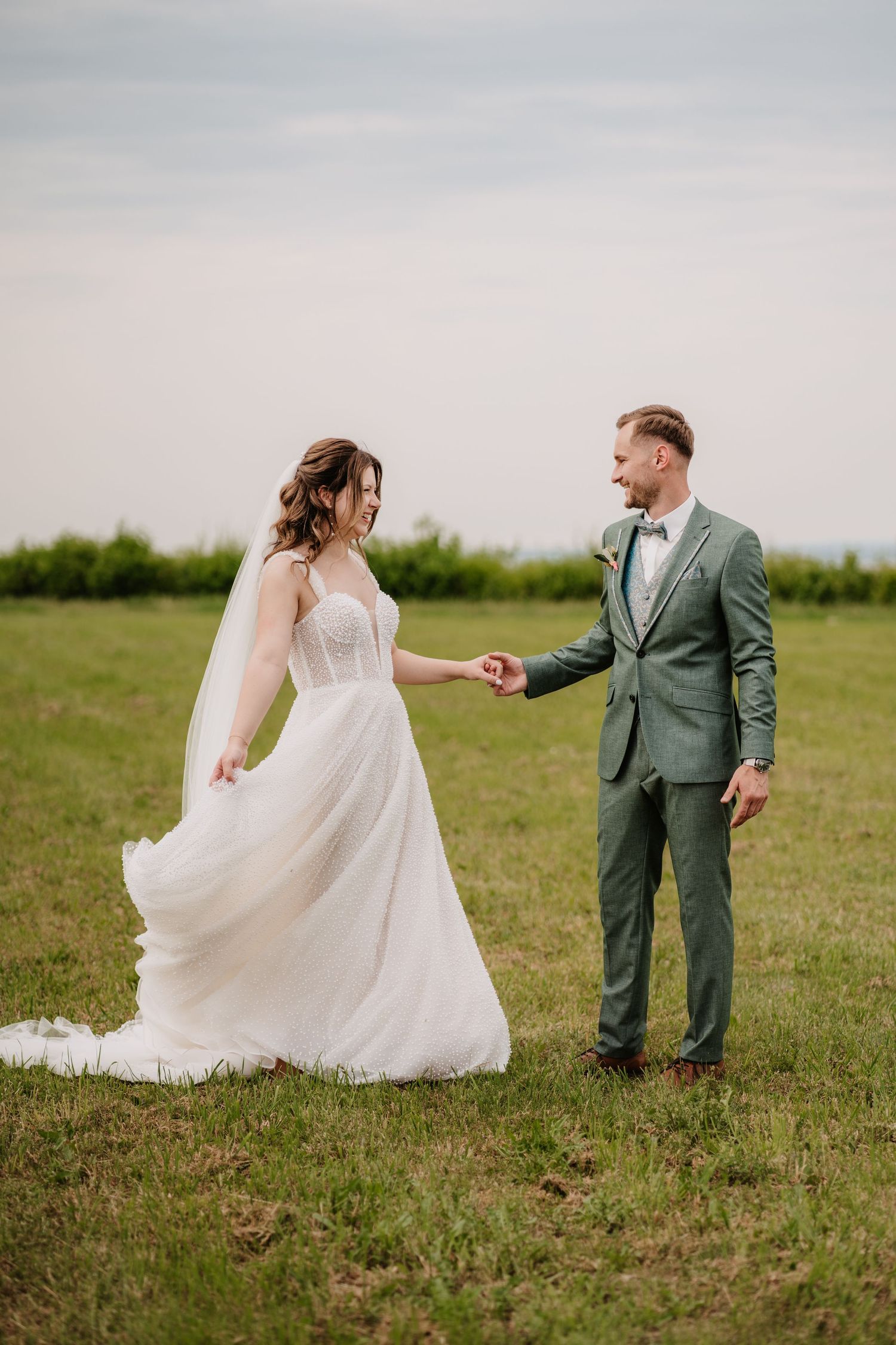 A romantic sunset wedding photoshoot with a couple in intimate poses wearing formal attire.