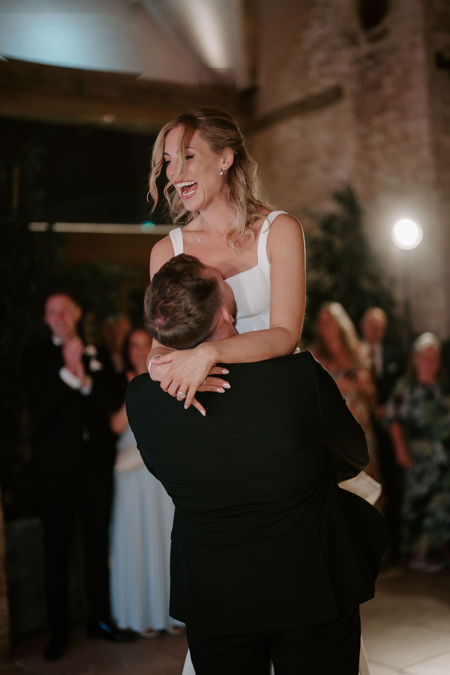 groom lifting bride during first dance as bride laughs at ivy lodge wedding in cirencester
