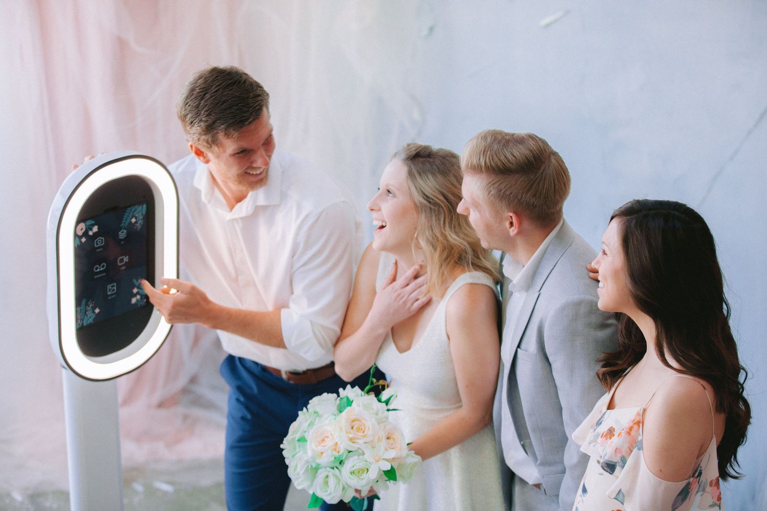 Wedding party members dance and celebrate together during a joyful reception celebration.