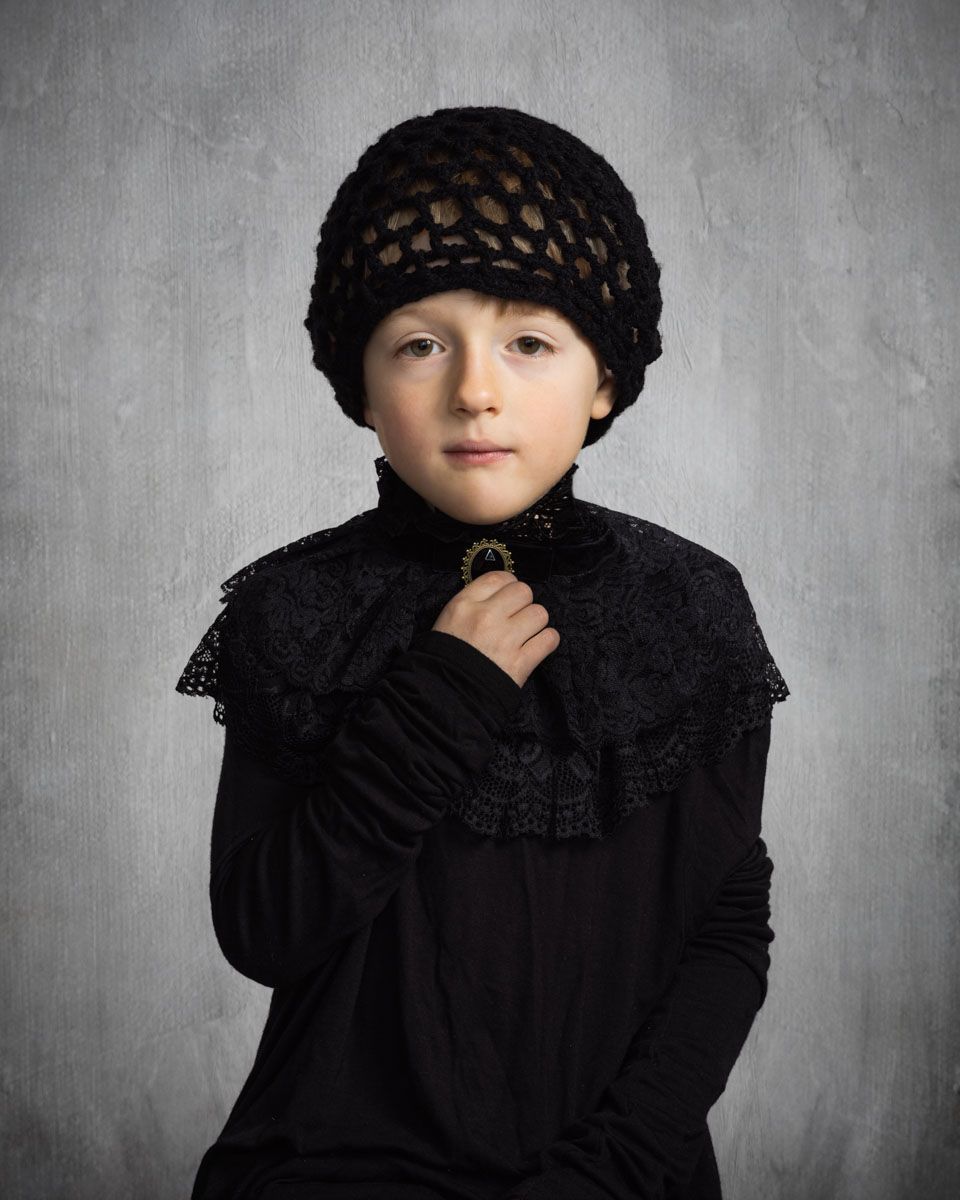 Fine art portrait of little boy, with striking styling of clothes