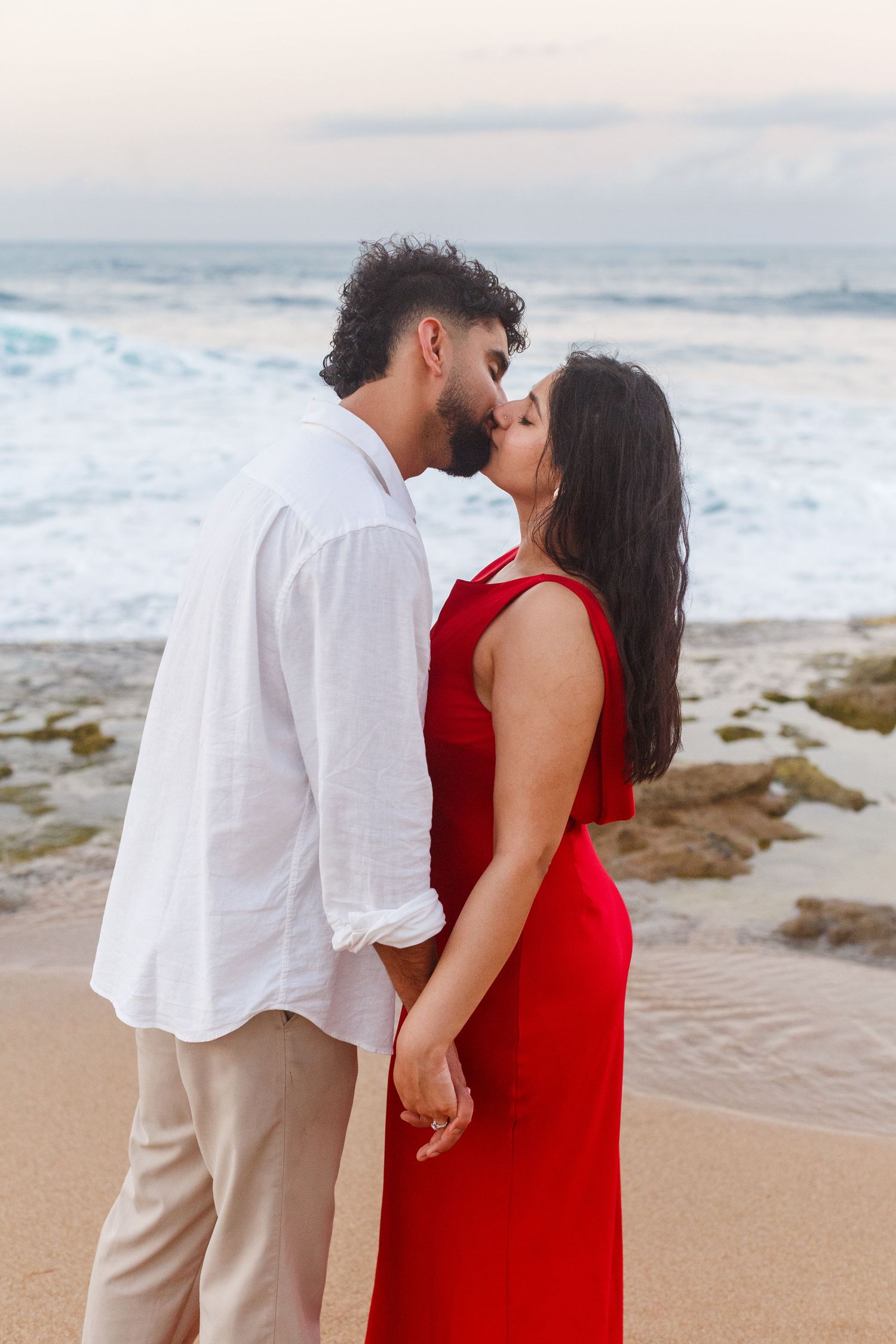 Couples portrait. Proposal and engagement session. Man and woman on the beach kissing. Kikita Surf Beach, Dorado, Puerto Rico.