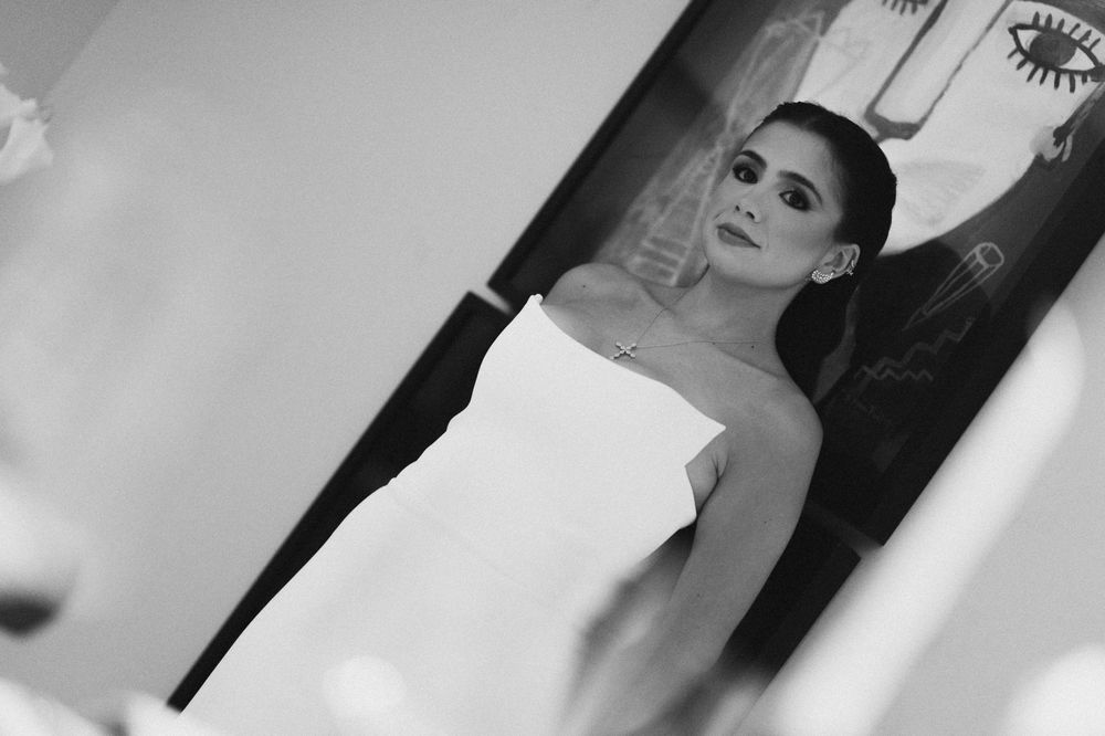Black and white fashion portraits showing dramatic poses and lighting against a simple background.