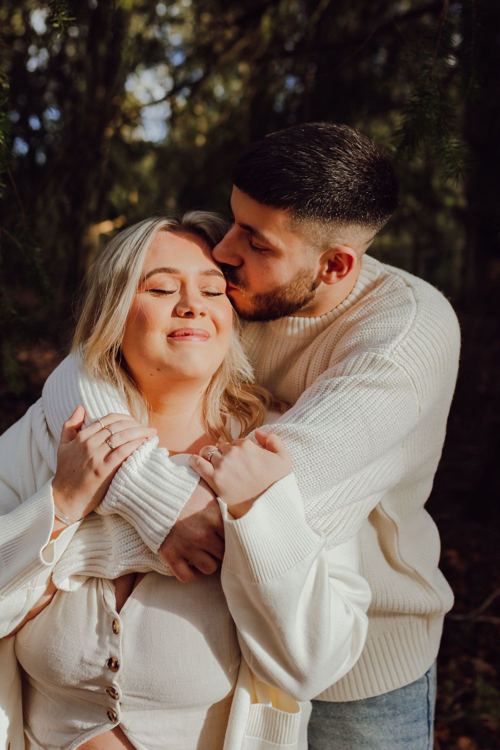 Romantic portrait of an engaged couple in soft winter light.