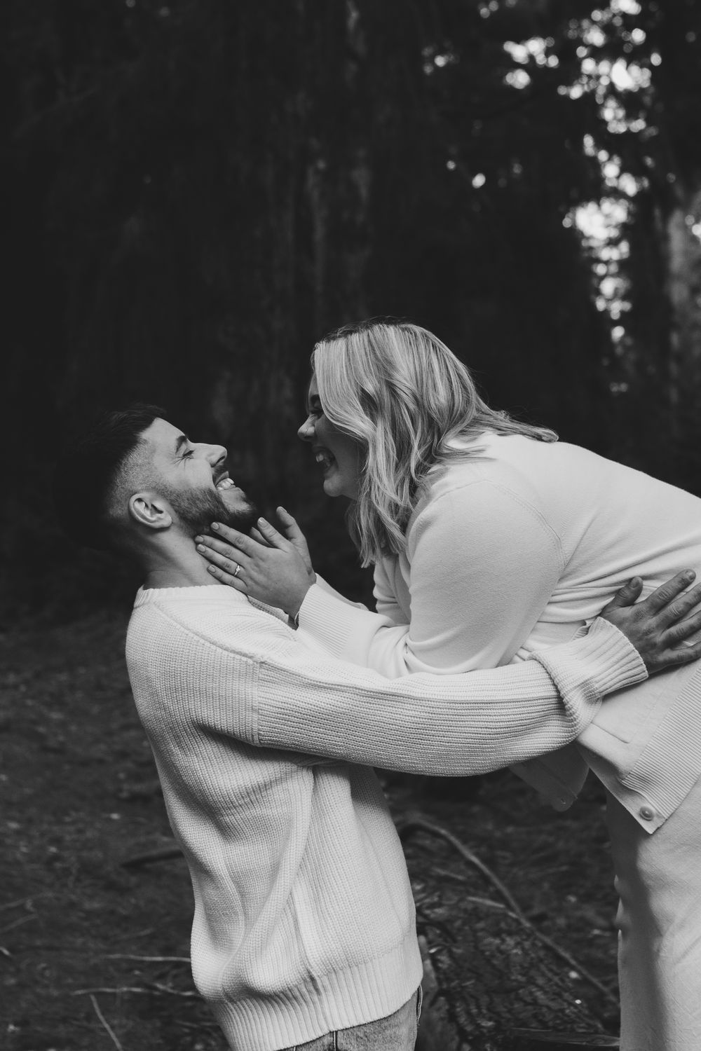 Hannah and Jordan are smiling at each other during their February engagement session.