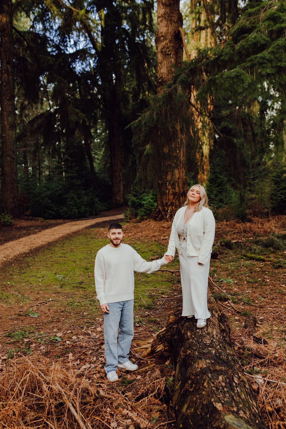 Hannah and Jordan are standing side by side during their outdoor engagement shoot.