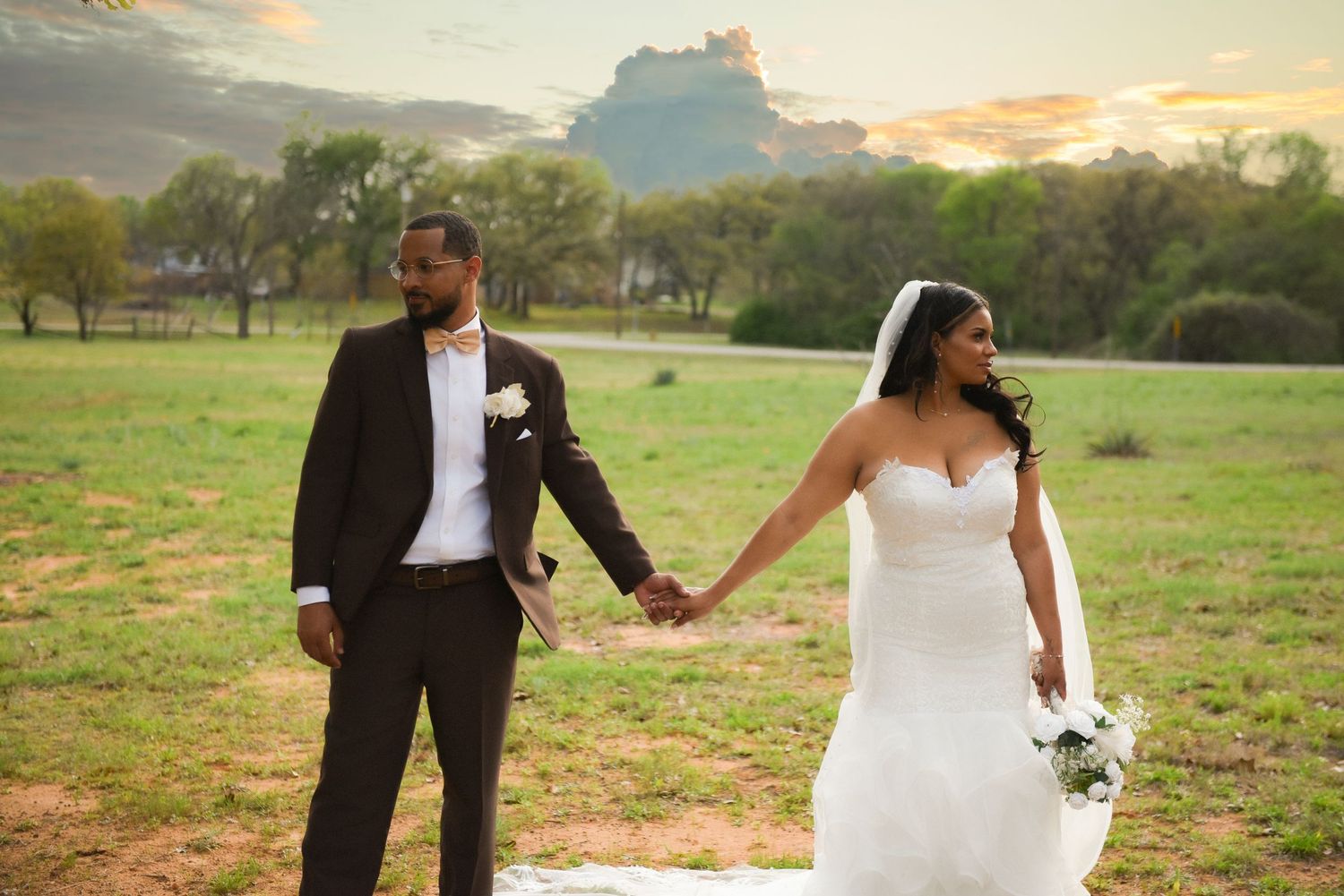 A series of romantic wedding photos captured at sunset in an outdoor field with mountains in the background.
