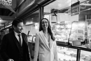 Couple sharing a joyful moment while shopping at a market stall.