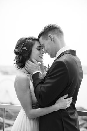 Intimate black and white portrait of couple in tender moment.