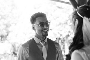 Candid black and white photo of a couple sharing a happy moment at their wedding.