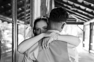 Emotional black and white wedding photograph capturing an intimate embrace.