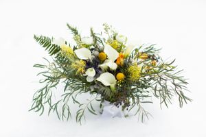 Winter wedding bouquet with yellow flowers, white blooms and ferns on white background.