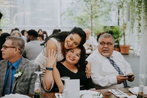 Wedding guests enjoying a lively moment during the reception celebration.