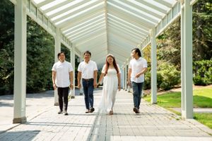 Family walks together through modern covered walkway with glass ceiling.
