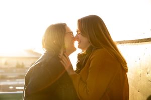 Two people share an intimate moment in golden hour light.
