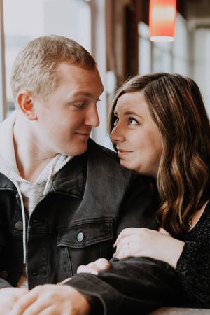 An intimate portrait of a couple gazing at each other indoors.