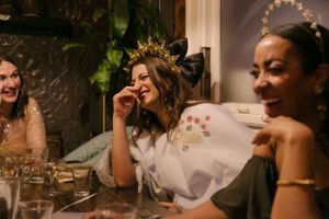A candid moment of laughter and joy at an intimate indoor celebration.