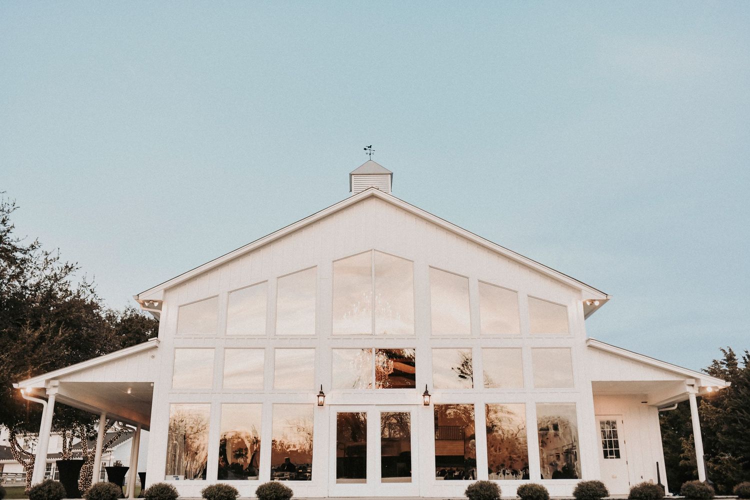 Exterior view of Firefly Gardens wedding venue showcasing modern rustic architecture