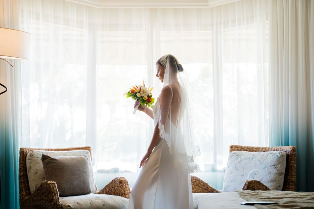 Ethereal bridal portraits captured through sheer white curtains.