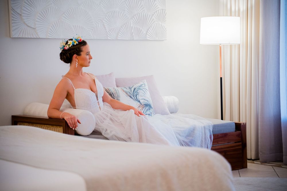 A serene bridal preparation scene in a bright white hotel room with modern furnishings.