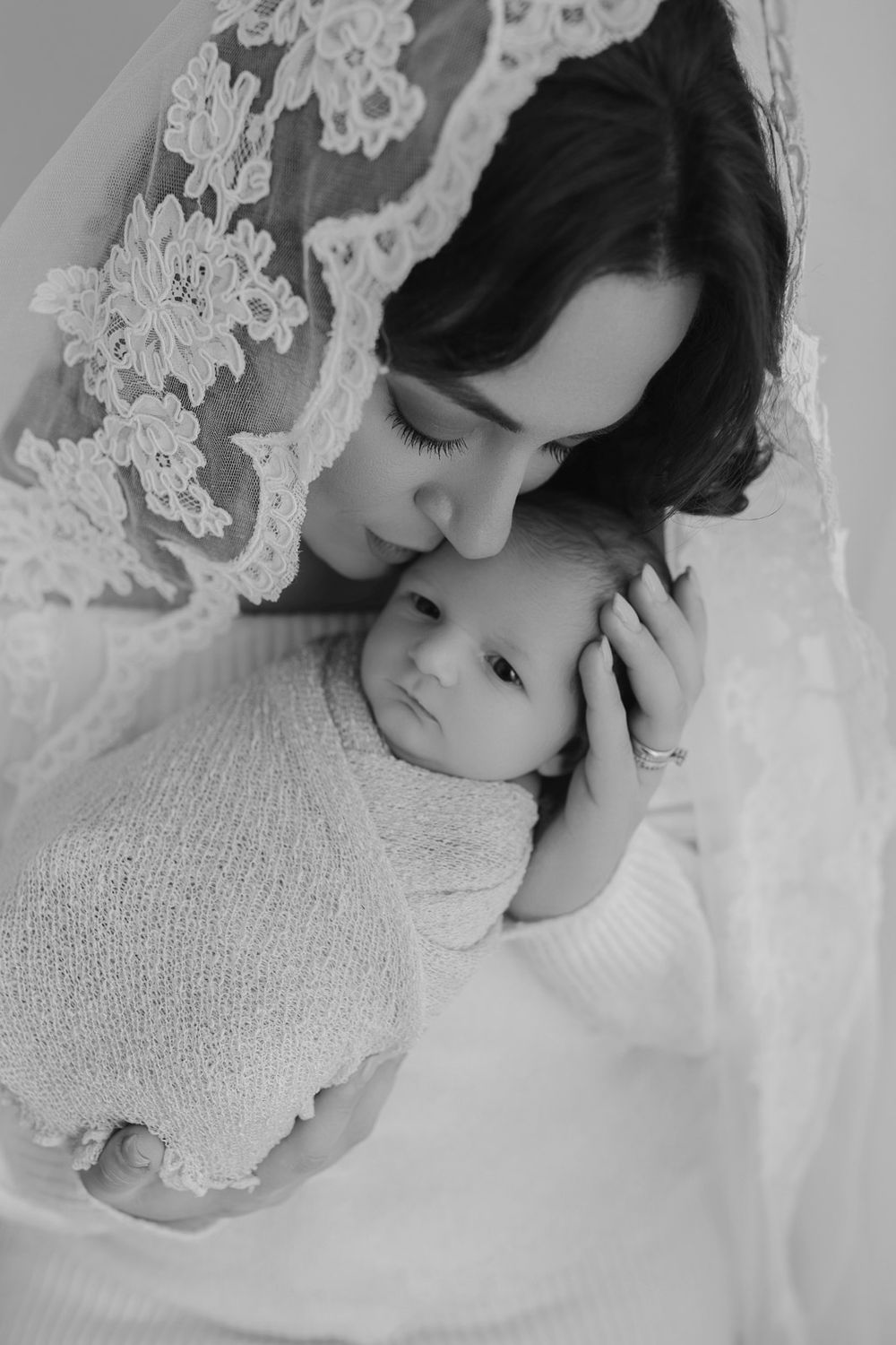 A black and white artistic portrait series showing delicate poses against white lace and fabric backgrounds.