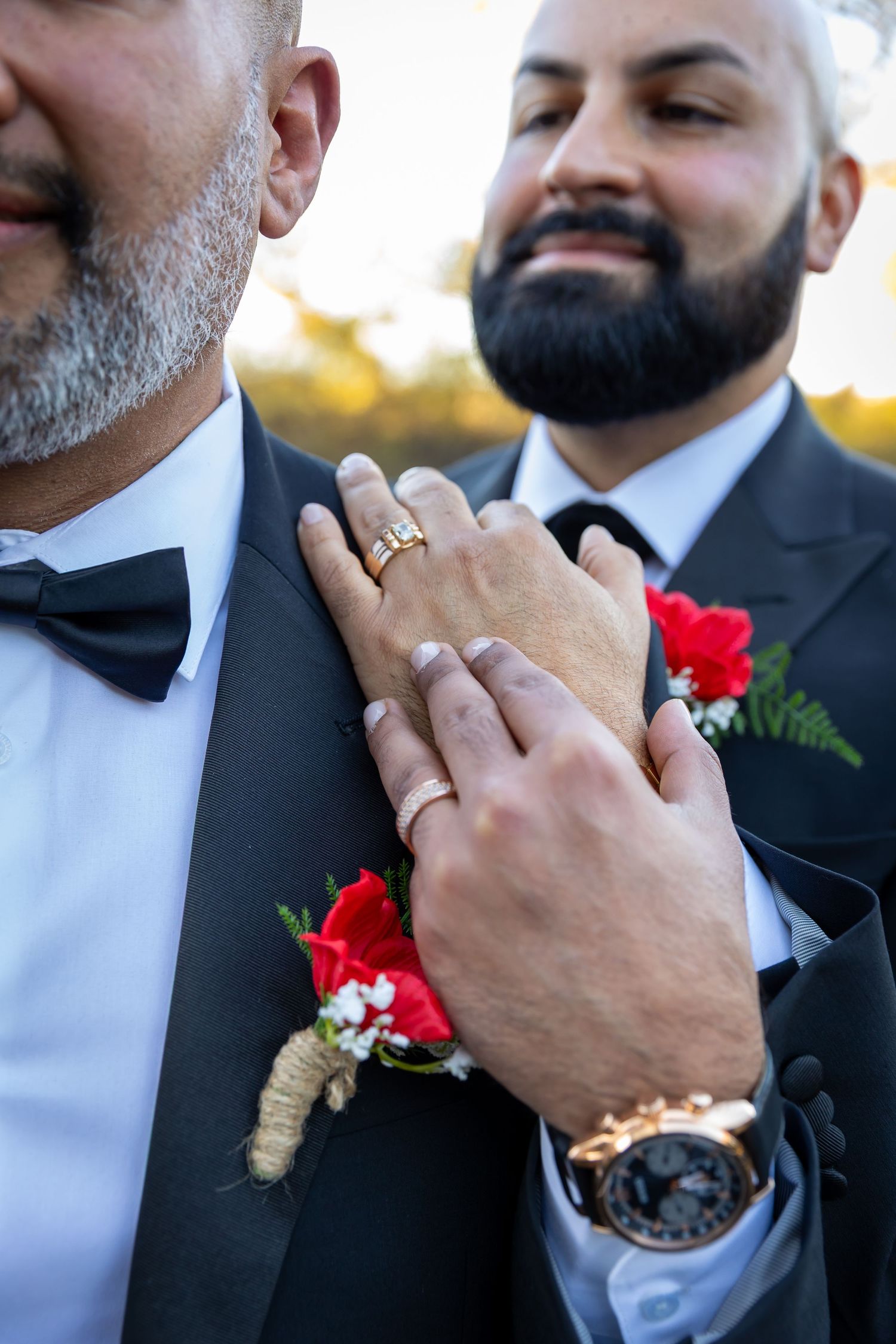 Close-up sequence showing hands in dark suit examining and adjusting a ring in natural lighting.