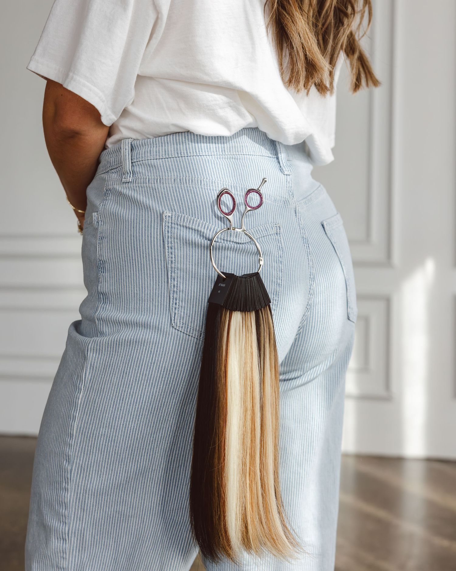 Close-up shots of light blue striped pants with back pockets shown from different angles in white room.