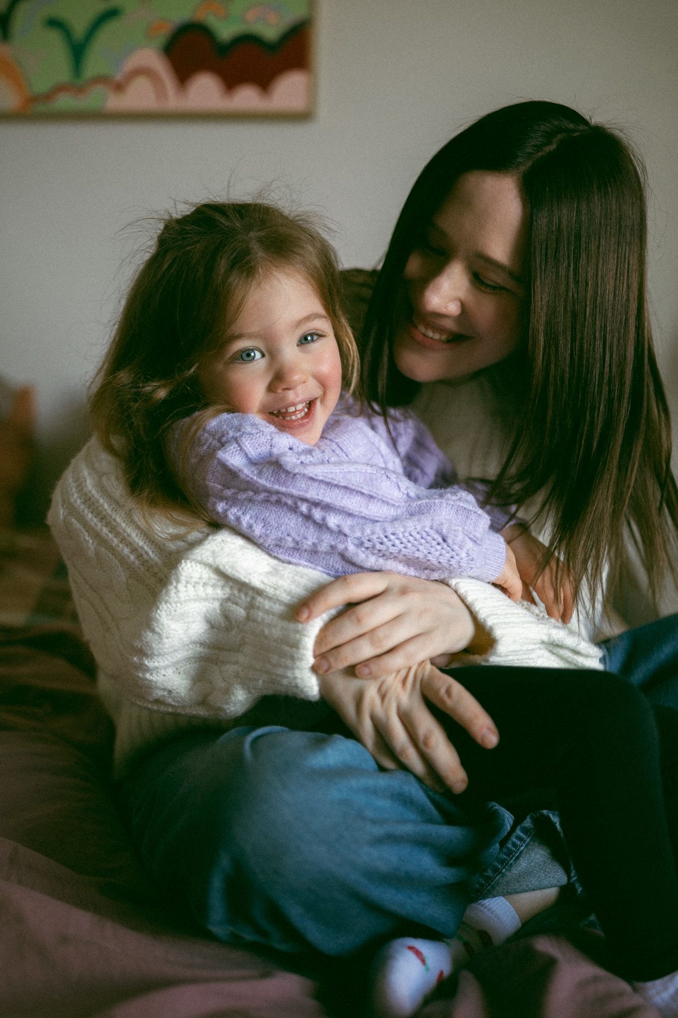 A series of intimate black and white photos showing a parent cradling and nursing a newborn baby.