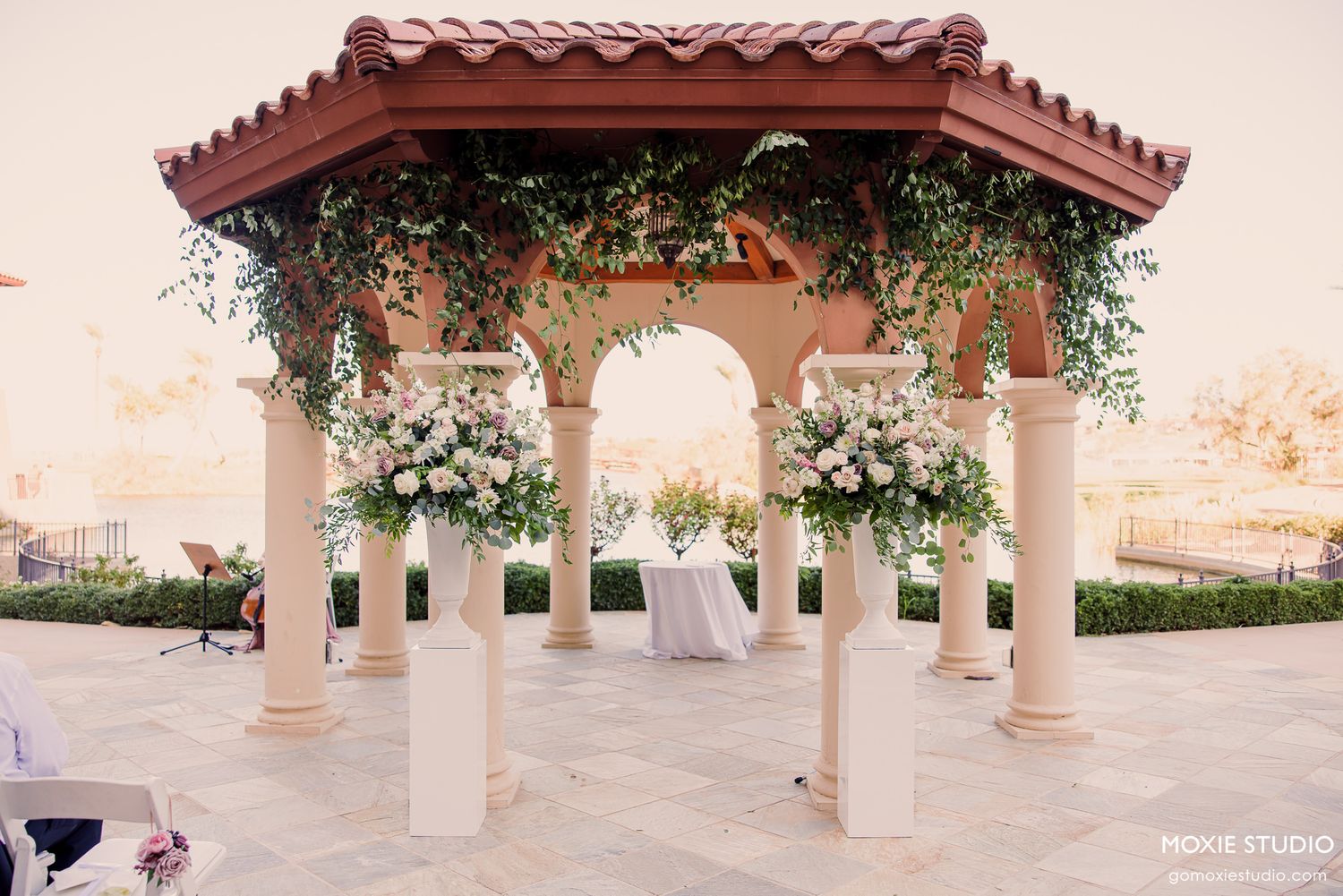 Black and white wedding photos showing a bride in a flowing white dress with a long veil in an elegant hallway setting.